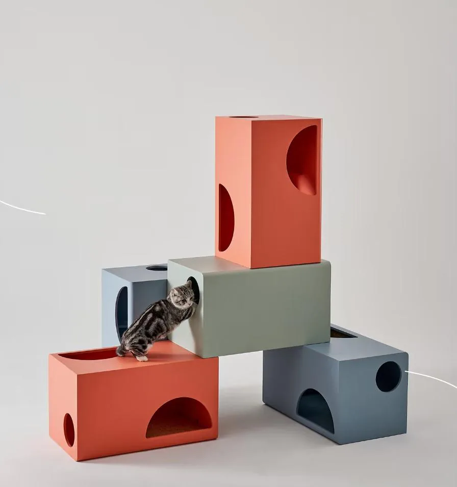 Modular climbing blocks in red and blue with a cat on top